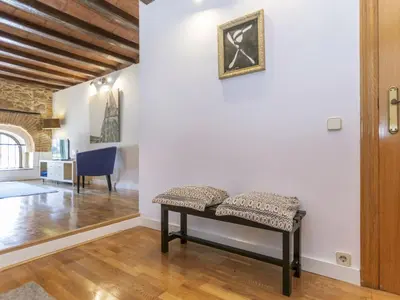 a bench in a living room with a picture on the wall at Apartment Icaria by Interhome in Barcelona
