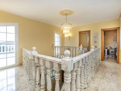 a staircase in a home with a chandelier at Holiday Home Bon repos by Interhome in Cunit