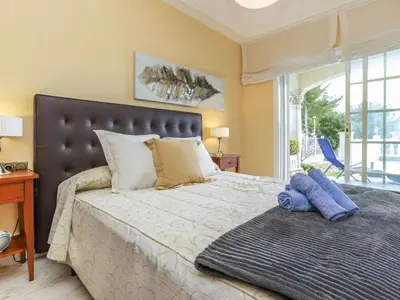 a bedroom with a large bed with a large window at Holiday Home Bon repos by Interhome in Cunit