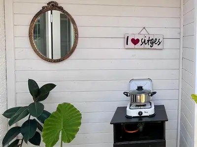 a table with a tea kettle on top of it at Sitges Garden Suite in Sitges