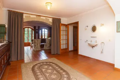 a living room with a sink and a table at Masia Can Cenç in Collsuspina