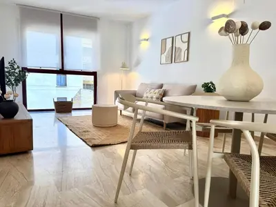 a living room with a table and a couch at Boutique Temporada VG Barcelona Sant Gervasi in Barcelona