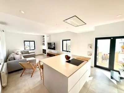 a kitchen and living room with a couch and a table at Mi casa soñada in Sant Pere de Ribes