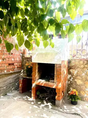 a brick fireplace with a cover on top of it at Mi casa soñada in Sant Pere de Ribes