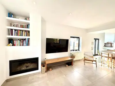 a living room with a fireplace and a flat screen tv at Mi casa soñada in Sant Pere de Ribes