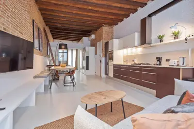 a kitchen and living room with a wooden ceiling at Alcam Gracia in Barcelona