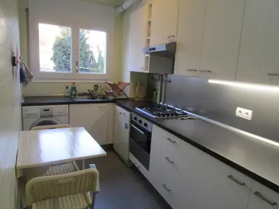 a kitchen with a sink and a stove top oven at Acogedor apartamento en el centro de Sitges in Sitges
