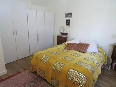 a bedroom with a bed with a yellow blanket at Acogedor apartamento en el centro de Sitges in Sitges