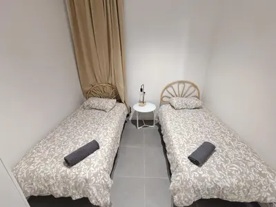 two beds sitting next to each other in a room at Charming apartment Poblenou beach in Barcelona