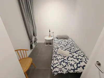 a room with a bed and a table and a table at Charming apartment Poblenou beach in Barcelona