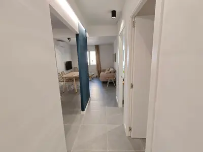 a hallway leading to a living room with a table at Charming apartment Poblenou beach in Barcelona
