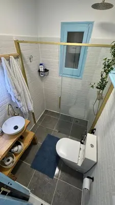 a bathroom with a shower and a toilet and a sink at Casa con vistas al mar y jardín in Canet de Mar