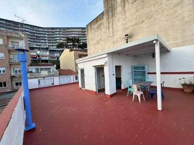 a patio with a table and chairs on a building at Casa con vistas al mar y jardín in Canet de Mar