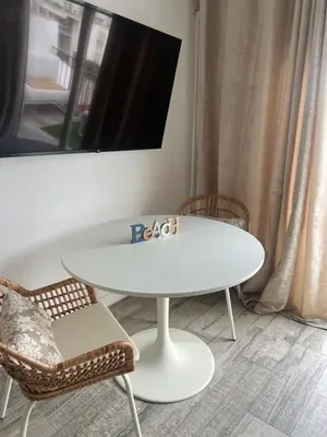 a white table and chairs in a room at Atico 1º linea vistas Sitges in Sitges