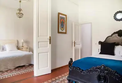 a bedroom with two beds and an open door at Céntrico y espacioso apartamento in Barcelona