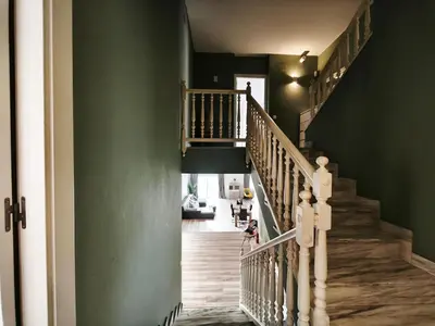 a woman walking down a staircase in a house at Luxury Villa in Vallromanes - Mountain Views, Pool, Close to Barcelona and the Beach in Vallromanas