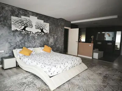 a bedroom with a large white bed with yellow pillows at Luxury Villa in Vallromanes - Mountain Views, Pool, Close to Barcelona and the Beach in Vallromanas