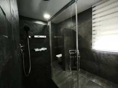 a bathroom with a glass shower with a toilet at Luxury Villa in Vallromanes - Mountain Views, Pool, Close to Barcelona and the Beach in Vallromanas