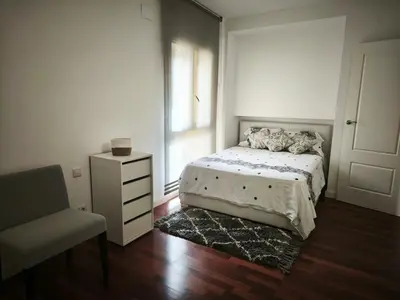 a bedroom with a bed and a chair and a window at Luxury Villa in Vallromanes - Mountain Views, Pool, Close to Barcelona and the Beach in Vallromanas