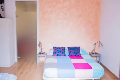 a bedroom with a bed with colorful pillows at Central apartment in Sant Antoni in Barcelona