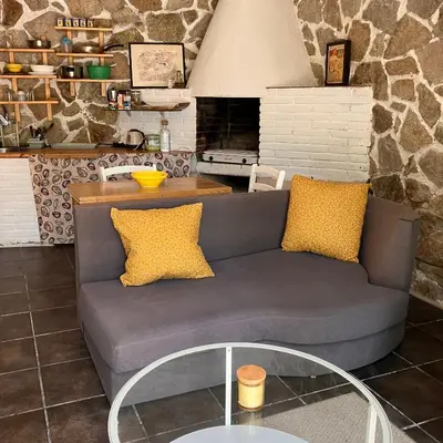 a living room with a couch and a table at Estudio limonero en Sant Cebriá de Vallalta 20' playa in Sant Cebrià de Vallalta