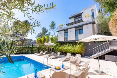 a villa with a swimming pool and a house at Cool and Stylish Villa Avanti with Private Pool, Beautiful Views and Air Conditioniing in Olivella