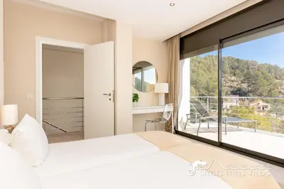 a kitchen with white cabinets and vegetables on the counter at Cool and Stylish Villa Avanti with Private Pool, Beautiful Views and Air Conditioniing in Olivella