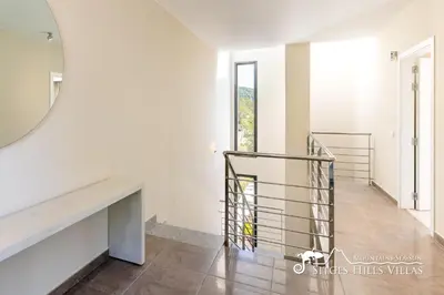 a bathroom with a toilet and a sink and a mirror at Cool and Stylish Villa Avanti with Private Pool, Beautiful Views and Air Conditioniing in Olivella