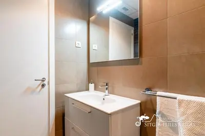 a bathroom with a sink and a mirror at Cool and Stylish Villa Avanti with Private Pool, Beautiful Views and Air Conditioniing in Olivella
