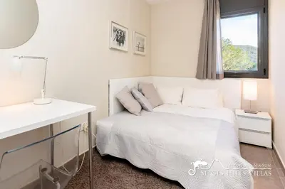 a white bedroom with a bed and a window at Cool and Stylish Villa Avanti with Private Pool, Beautiful Views and Air Conditioniing in Olivella