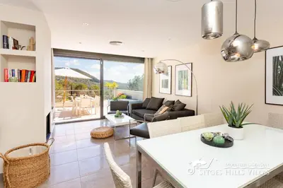 a white table with a plate of food and an umbrella at Cool and Stylish Villa Avanti with Private Pool, Beautiful Views and Air Conditioniing in Olivella