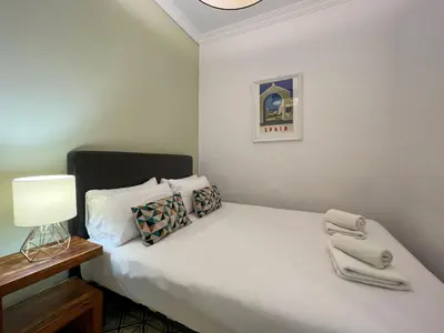 a small bedroom with a bed with towels on it at Stay U-nique Apartments Comte Urgell in Barcelona