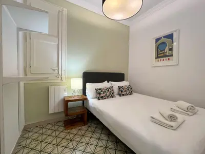 a bedroom with a bed with towels on it at Stay U-nique Apartments Comte Urgell in Barcelona