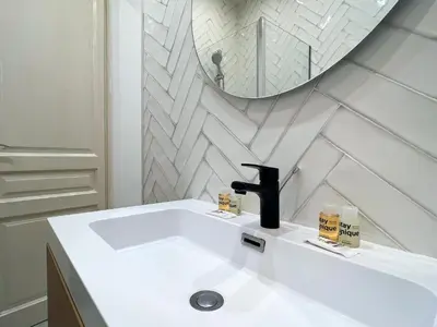 a white bathroom with a sink and a mirror at Stay U-nique Apartments Comte Urgell in Barcelona