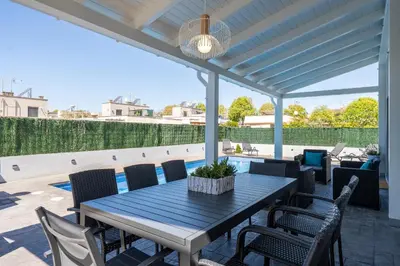 a patio with a table and chairs on a roof at Hauzify I Casa Somella in Vilanova i la Geltrú