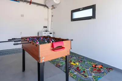 a table with a toy gun in a room at Hauzify I Casa Somella in Vilanova i la Geltrú