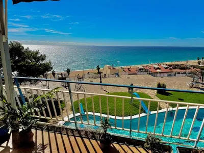 a view of a swimming pool and the beach at Apartamento Canet de Mar - Primera linea de Playa - Increibles vistas al Mar in Canet de Mar