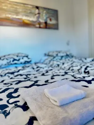 a bed with two towels sitting on top of it at Apartamento Canet de Mar - Primera linea de Playa - Increibles vistas al Mar in Canet de Mar