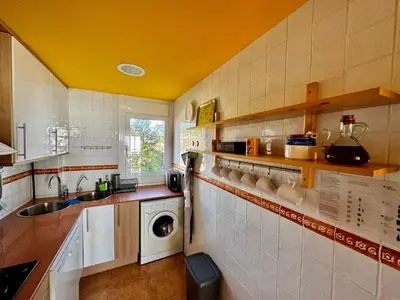 a kitchen with a sink and a washing machine at Apartamento Canet de Mar - Primera linea de Playa - Increibles vistas al Mar in Canet de Mar