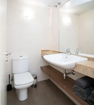 a bathroom with a white toilet and a sink at Av d'Eduard Maristany, 13 in Sant Adria de Besos
