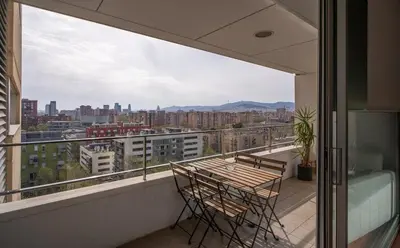 a balcony with a table and chairs and a view at Av d'Eduard Maristany, 13 in Sant Adria de Besos
