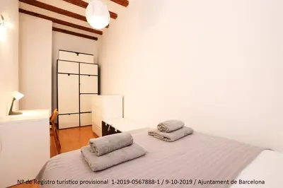 a bedroom with a bed with two pillows on it at La Rambla - Catalonia Square Apt 4BD-2BTH in Barcelona