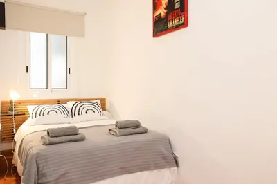 a bedroom with a bed with two towels on it at La Rambla - Catalonia Square Apt 4BD-2BTH in Barcelona