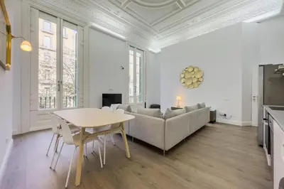 a living room with a table and a couch at Precioso apartamento en Rambla Cataluña 35 in Barcelona