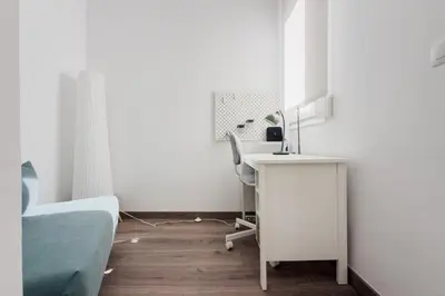 a bedroom with a desk and a bed and a desk and chair at Precioso apartamento en Ronda Sant Pau in Barcelona