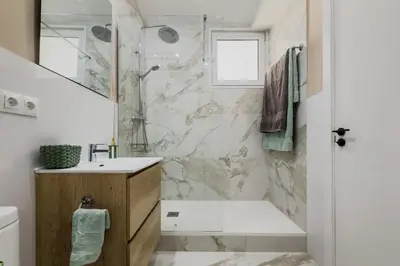 a bathroom with a shower and a tub and a sink at Precioso apartamento en Ronda Sant Pau in Barcelona