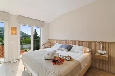 a bedroom with a large bed with flowers on it at L'Hostalet de Cabrils in Cabrils