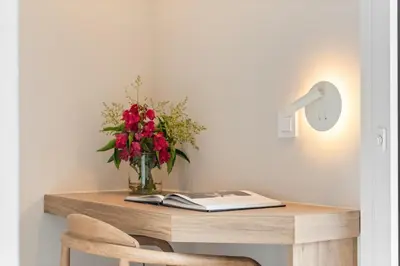 a table with a vase of flowers and a book at L'Hostalet de Cabrils in Cabrils