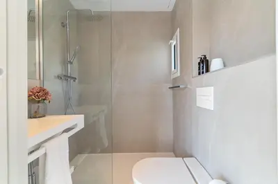 a bathroom with a toilet and a glass shower at L'Hostalet de Cabrils in Cabrils
