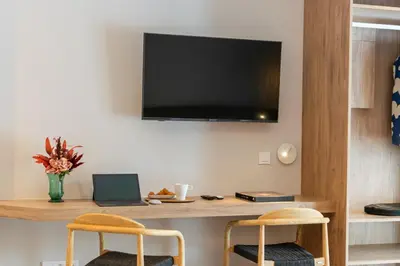 a living room with a desk with a laptop and two chairs at L'Hostalet de Cabrils in Cabrils